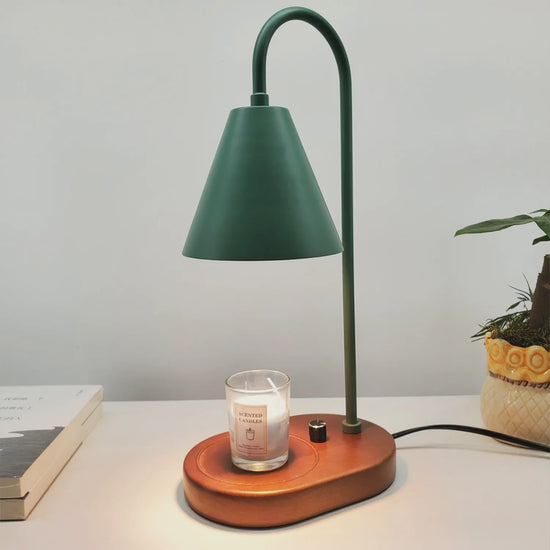 Electric candle warmer lamp lit over a jar candle, shown in green, black and white
