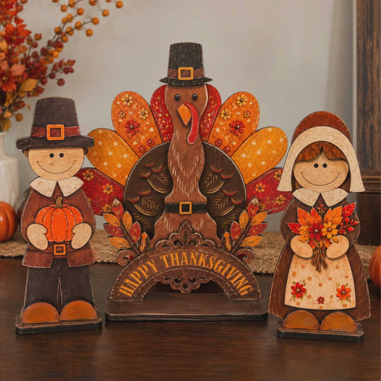 Three wooden Thanksgiving pilgrim and turkey tabletop decorations
