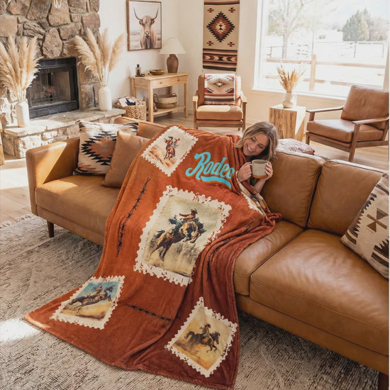 A western Rodeo throw blanket draped over a sofa and armchair